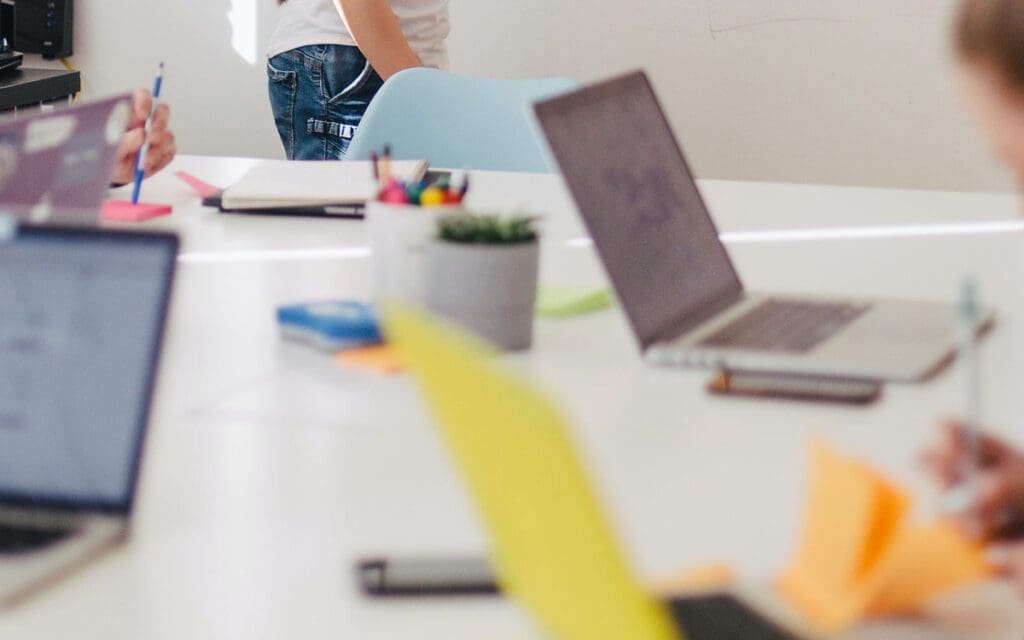 people in an office on laptops