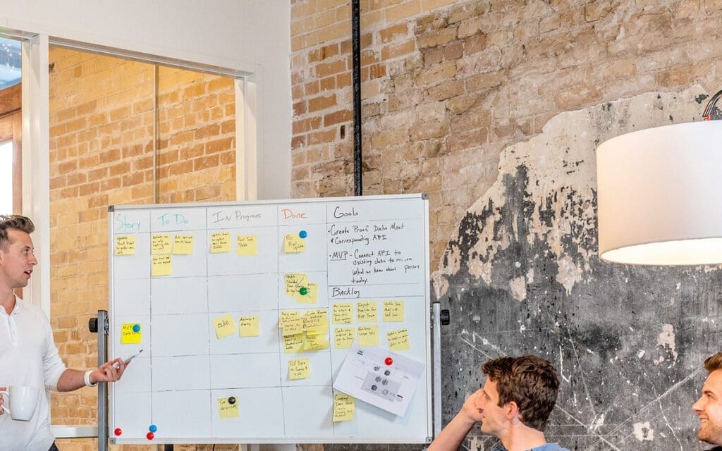 person writing on whiteboard