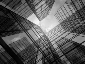 a photo of glass buildings shot from the bottom looking up
